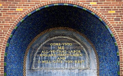 A stone archway with text  Description automatically generated